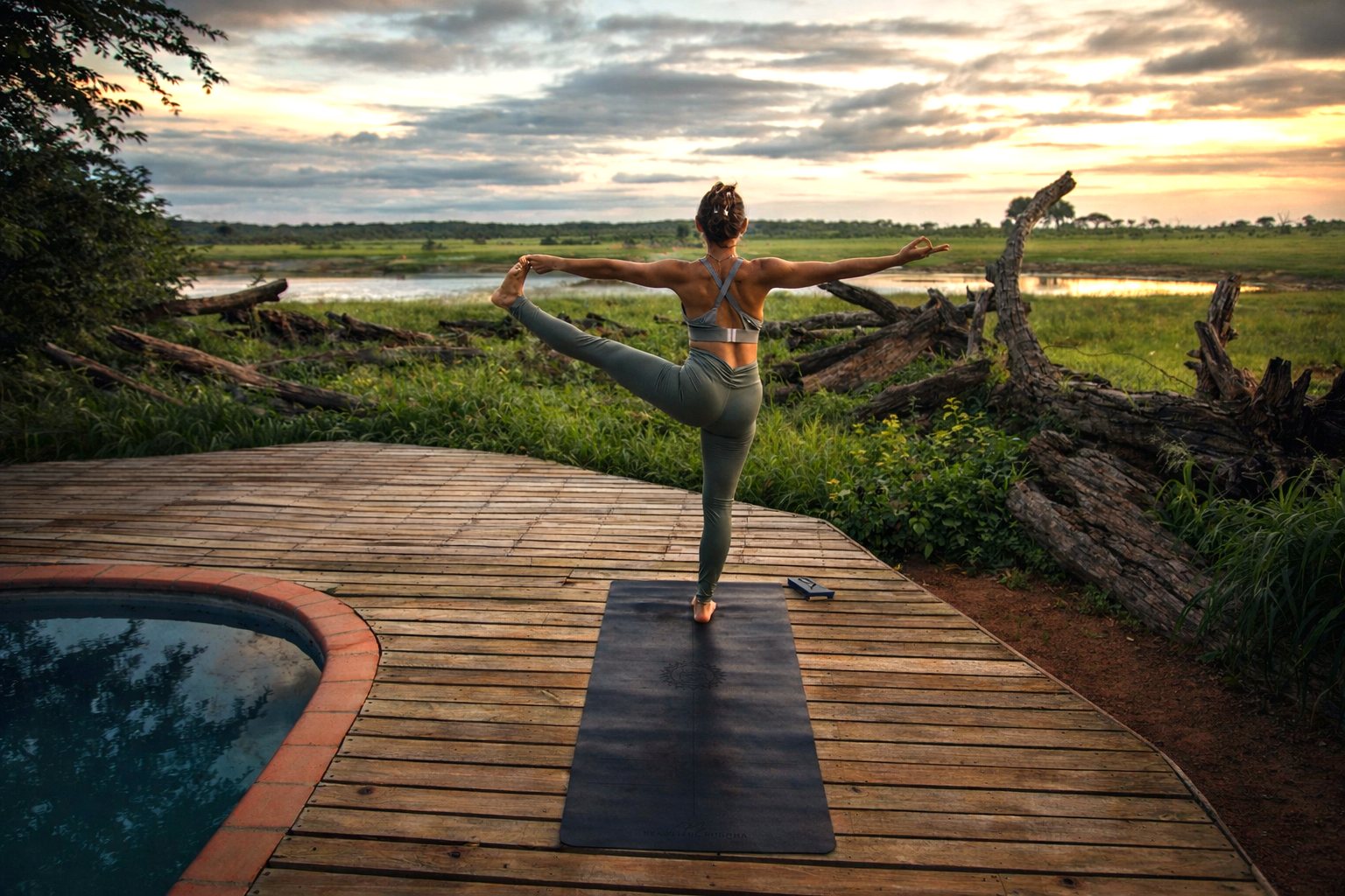 Yoga practice on a deck overlooking the Zambezi at dusk