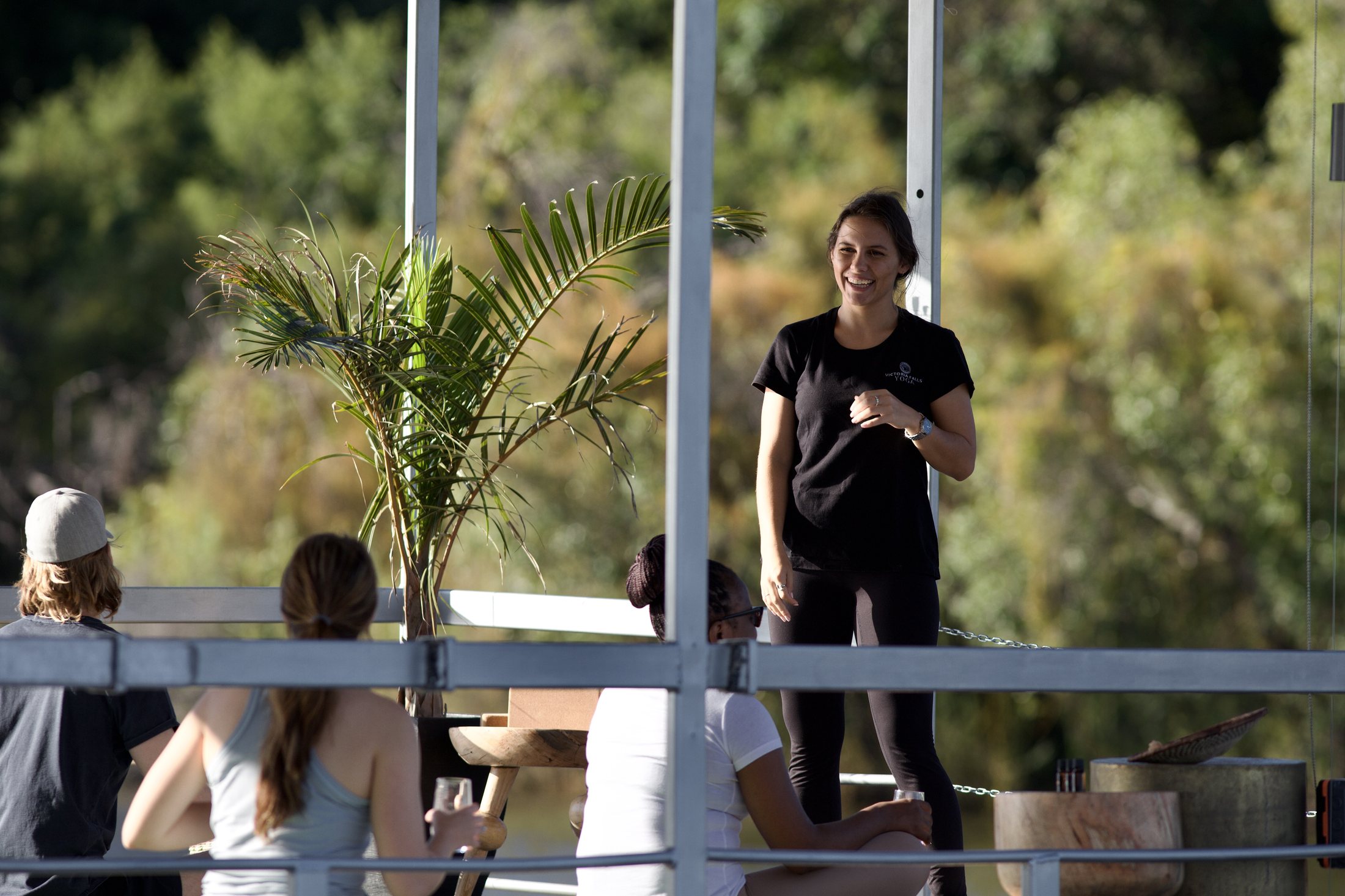 Victoria Falls Yoga guide leading a session on the Zambezi River deck