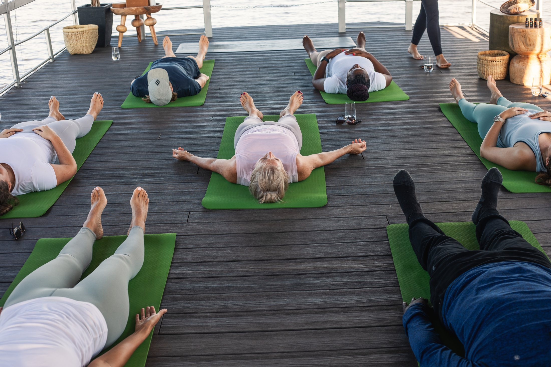 Overhead view of savasana on the river deck
